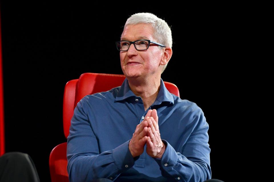 Tim Cook Apple sitting on a red chair