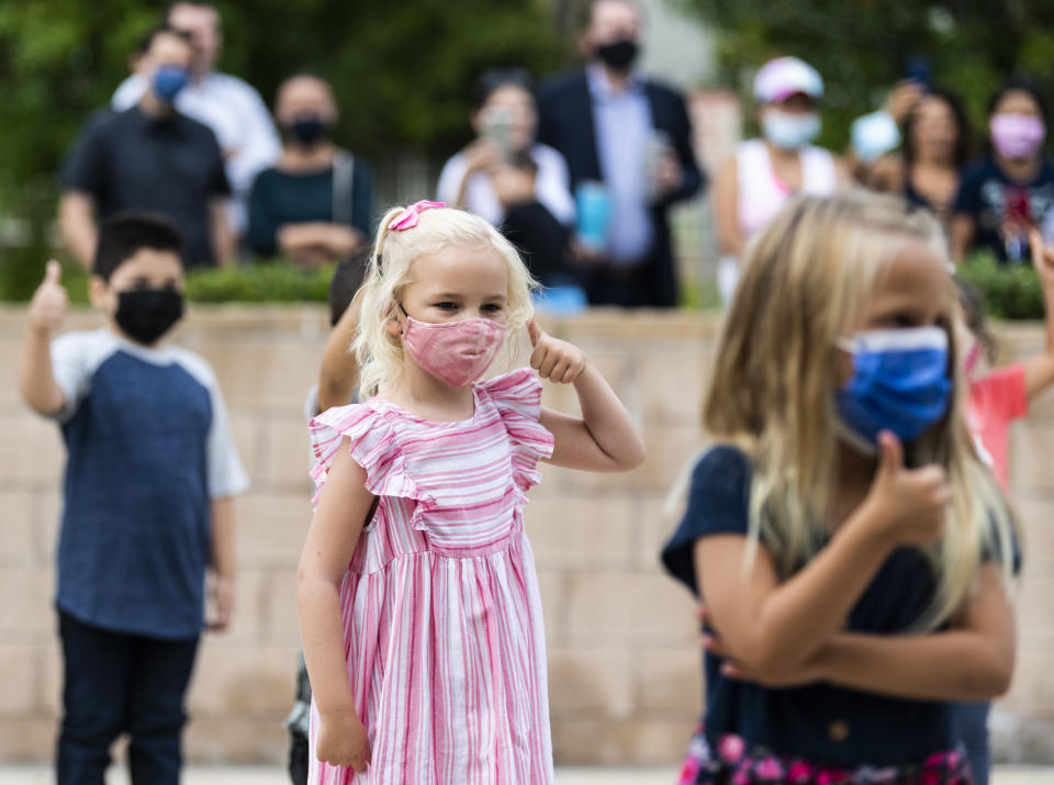 Laguna Niguel, CA - August 17: A kindergarten student gives the thumbs up to her teacher before starting the first day of kindergarten at Laguna Niguel Elementary School in Laguna Niguel, CA on Tuesday, August 17, 2021. (Photo by Paul Bersebach, MediaNews Group/Orange County Register via Getty Images)