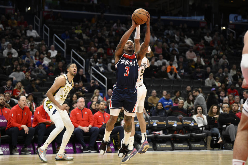 Washington Wizards guard Bradley Beal (3) goes to the basket past Indiana Pacers guard Andrew Nembhard (2) and guard Tyrese Haliburton (0) during the first half of an NBA basketball game Saturday, Feb. 11, 2023, in Washington. (AP Photo/Nick Wass)