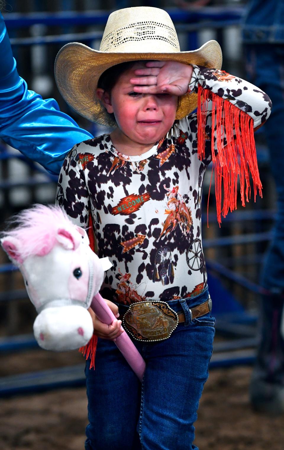 Emmalee Coonrod momentarily feels the pressure before jumping in to compete in the age 3-4 year-old barrel racing.