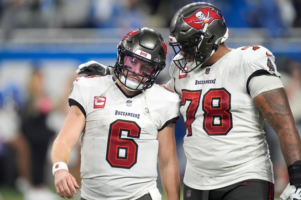 Tampa Bay Buccaneers quarterback Baker Mayfield (6) and offensive tackle Tristan Wirfs (78) walk to the bench after a pass by Mayfield was intercepted by the Detroit Lions during the second half of an NFL football NFC divisional playoff game, Sunday, Jan. 21, 2024, in Detroit. The Lions won 31-23. (AP Photo/Carlos Osorio)