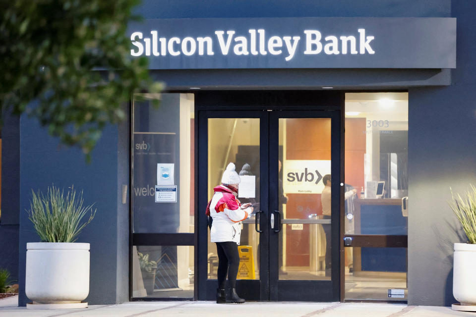 A customer takes a photograph of a newly posted letter at the Silicon Valley Bank headquarters in Santa Clara, California, U.S. March 13, 2023. REUTERS/Brittany Hosea-Small