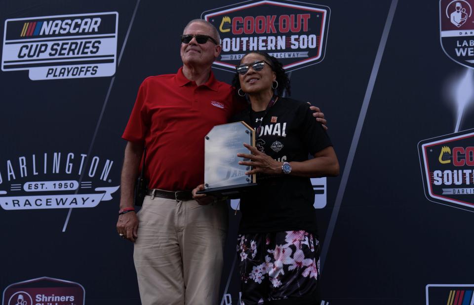 Darlington Raceway president Kerry Tharp with University of South Carolina women's basketball coach Dawn Staley after giving her a plaque for her role as Honorary Pace Car Driver prior to the COOK OUT Southern 500 at Darlington Raceway on Sep 4., 2022 in Darlington, South Carolina.