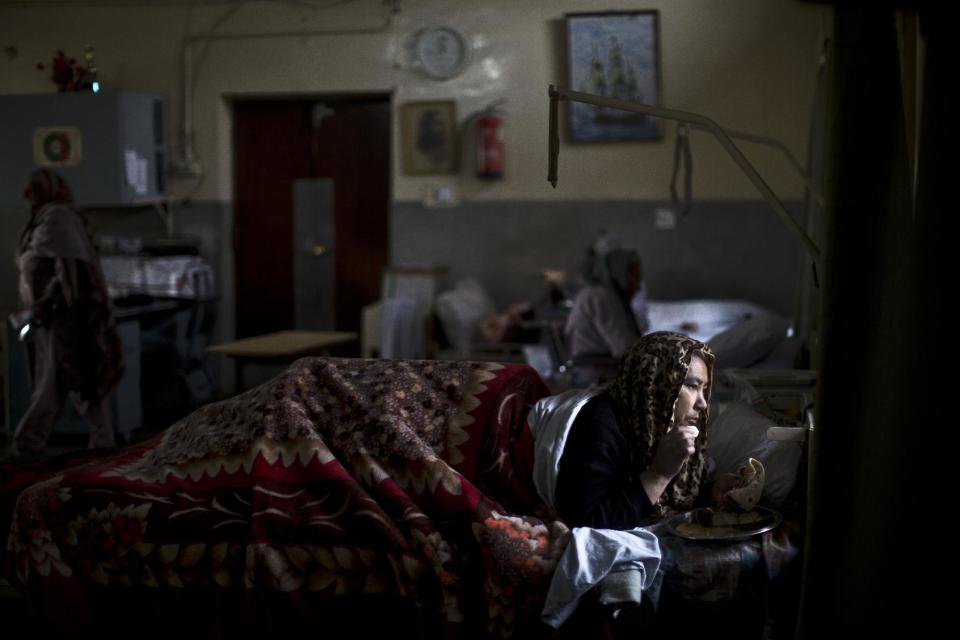 In this Saturday, Feb. 15, 2014, photo, Zohra Hussein, 51, a Pakistani patient who lives at St. Joseph’s Hospice for the last 31 years, lies in her bed having her lunch, at the female ward of the Hospice in Rawalpindi, Pakistan. Mohammed Aqeel spent weeks at home in Pakistan waiting for death after suffering a debilitating spinal cord injury in a car crash before friends suggested he come to St. Joseph’s Hospice on the outskirts of the capital, Islamabad. Now 13 years later, his life and those of some 40 others who live on its grounds might be changed forever as this hospital of last resort faces closure over its rising debts. (AP Photo/Muhammed Muheisen)