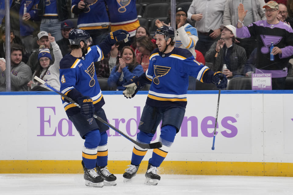 St. Louis Blues' Kevin Hayes, right, is congratulated by Nick Leddy (4) after scoring during the second period of an NHL hockey game against the Detroit Red Wings Tuesday, Dec. 12, 2023, in St. Louis. (AP Photo/Jeff Roberson)