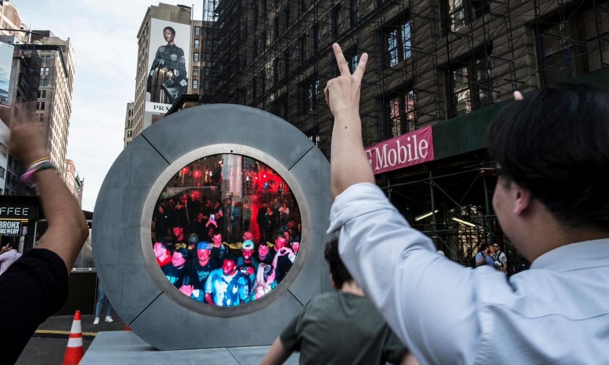 <span>New Yorkers on the street in Manhattan interact with a crowd in Dublin on the portal.</span><span>Photograph: Billy Tompkins/Zuma Press Wire/Rex/Shutterstock</span>