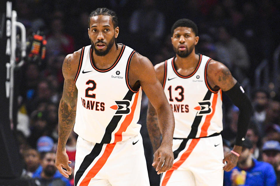 Kawhi Leonard and Paul George on defense during a game.