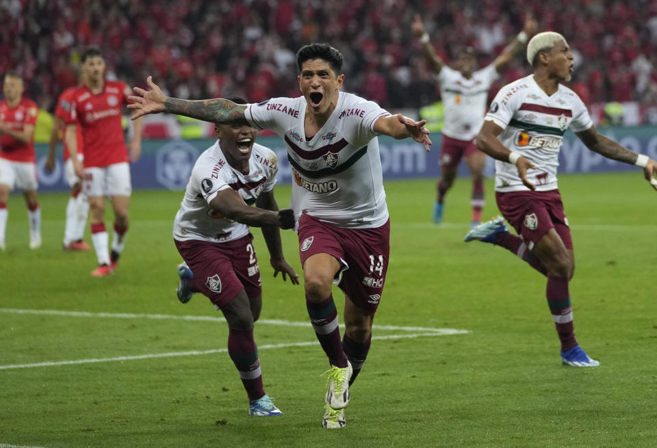 German Cano of Brazil's Fluminense, center, celebrates scoring his side's second goal against Brazil's Internacional during a Copa Libertadores semifinal second leg soccer match at Beira Rio stadium in Porto Alegre, Brazil, Wednesday, Oct. 4, 2023. (AP Photo/Andre Penner)