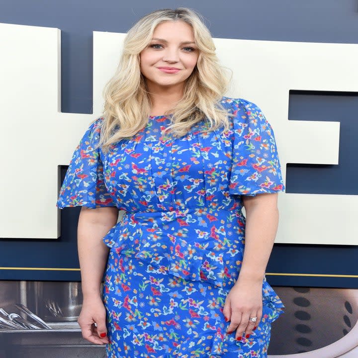 Abby on the red carpet un a floral-print dress