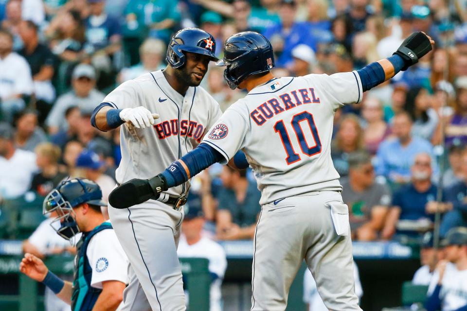 Houston Astros left fielder Yordan Alvarez (44) hugs first baseman Yuli Gurriel (10) after hitting a three-run home run against the Seattle Mariners.