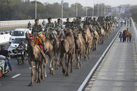 FILE - In this Feb. 21, 2020, file photo, Border Security Force (BSF) soldiers march on the route that U.S. President Donald Trump will travel in Ahmadabad, India. President Donald Trump is ready for a king's welcome as he head to India on Sunday for a jam packed two-day tour. The visit will feature a rally at one of the world's largest stadiums, a crowd of millions cheering him on and a lovefest with a like-minded leader during an election year. (AP Photo/Ajit Solanki, File)