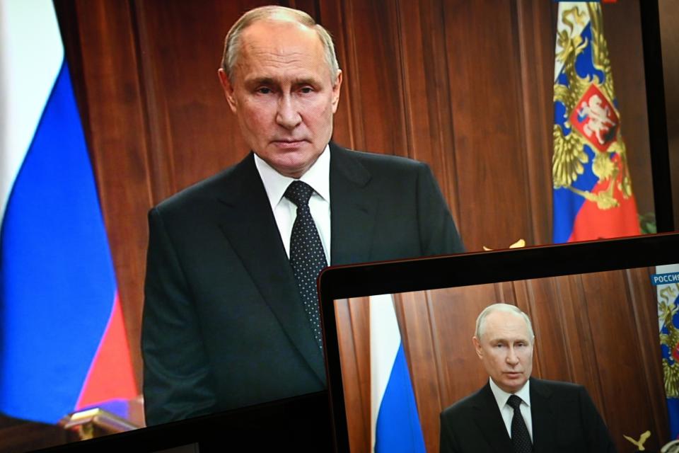 FILE - Russian President Vladimir Putin is seen on monitors as he addresses the nation after Yevgeny Prigozhin, the owner of the Wagner Group military company, called for armed rebellion and reached the southern city of Rostov-on-Don with his troops, in Moscow, Russia, Saturday, June 24, 2023. Until last week, the Kremlin has never admitted to funding the company, with private mercenary groups technically illegal in Russia. But President Vladimir Putin revealed the state paid Wagner almost $1 billion in just one year, while Prigozhin's other company earned about the same from government contracts. (Pavel Bednyakov, Sputnik, Kremlin Pool Photo via AP, File)