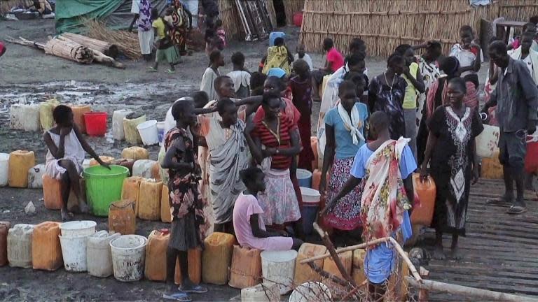 A grab from an UNMISS video shows displaced people gathering water at a camp in Bentiu on April 22, 2014