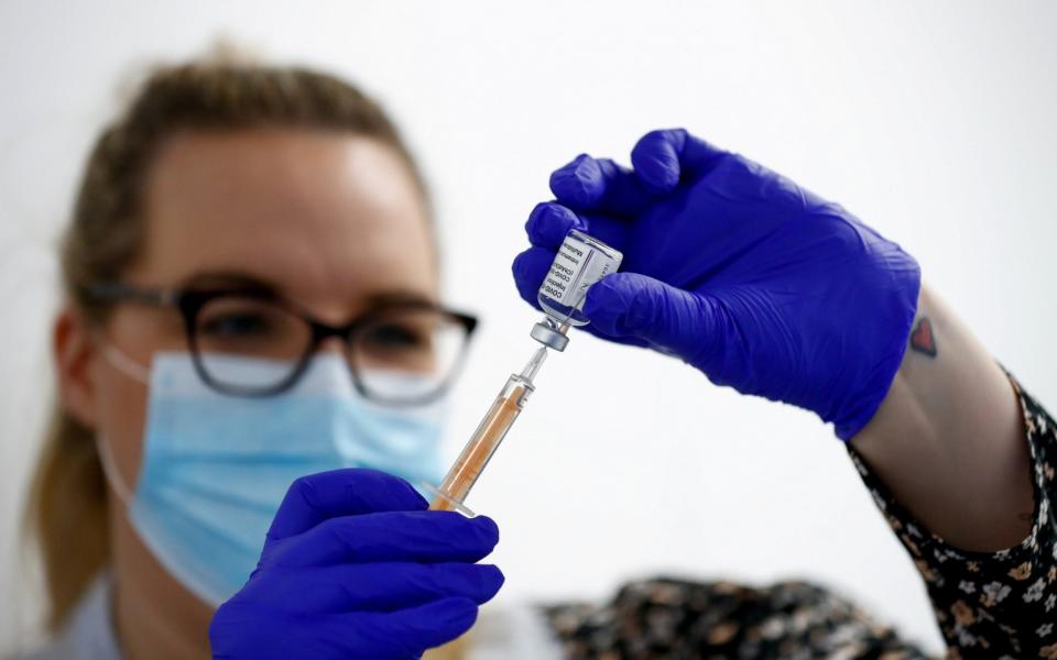 A health worker fills a syringe with a dose of the Oxford/AstraZeneca COVID-19 vaccine  - Reuters