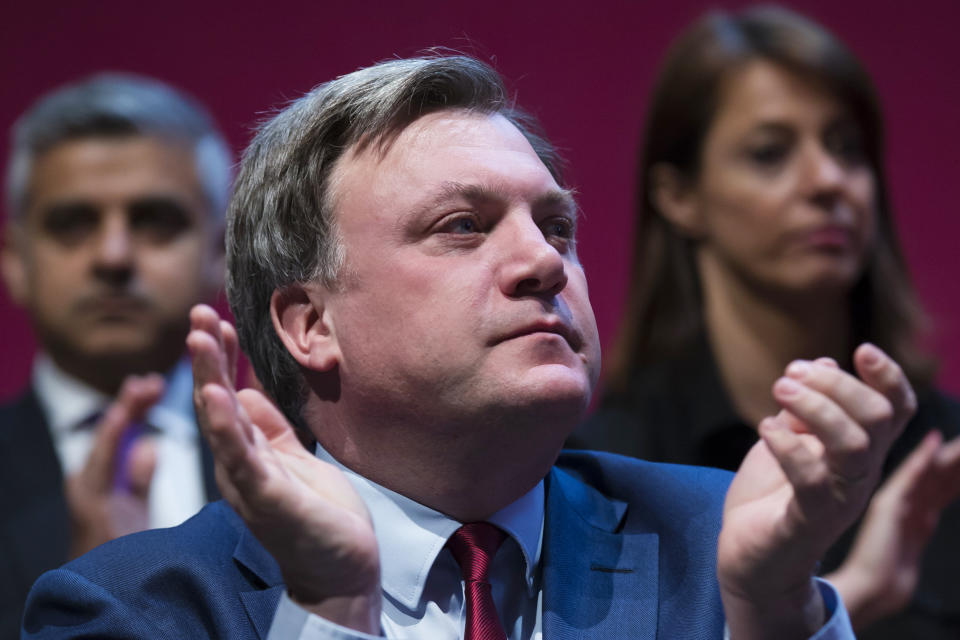 Shadow Chancellor, Ed Balls, applauds as Labour Party leader, Ed Miliband, speaks at the launch of his party's election manifesto , Monday April 13, 2015 as Britain's political parties campaign in the lead up to the parliamentary elections on May 7, Manchester, England. (AP Photo/Jon Super)