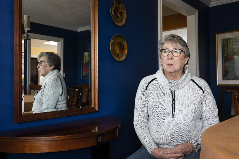 Joyce Ares sits for a portrait in the dinning room of her home on Friday, March 18, 2022, in Canby, Ore. Although Ares feels lucky, it’s impossible to know whether her cancer blood test added healthy years to her life or made no real difference, said Dr. Barry Kramer , former director of the National Cancer Institute’s Division of Cancer Prevention. “I sincerely hope that Joyce benefited from having this test,” Kramer said when told of her experience. Cancer treatments can have long-term side effects, he said, "and we don’t know how fast the tumor would have grown.” Treatment for Hodgkin lymphoma is so effective that delaying therapy until she felt symptoms might have achieved the same happy outcome. (AP Photo/Nathan Howard)
