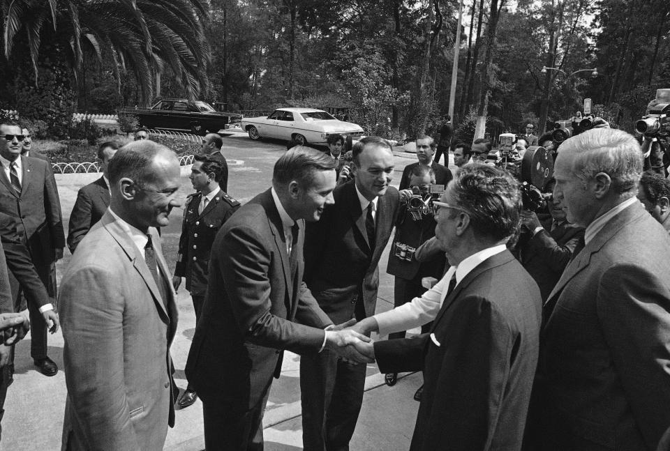 President Gustavo Diaz Ordaz of Mexico, right, and his wife, oscured by the President, greet U.S. Apollo 11 astronaut Neil Armstrong on he arrival, Monday, Sept. 29, 1969 in Mexico City of the moon travelers at the residence of the Mexican first family of Los Pinos. Watching the double handshake are Edwin Aldrin, left, and Michel Collins. (AP Photo)