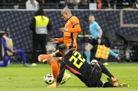 Germany's goalkeeper Marc-Andre ter Stegen, right, challenges Netherlands' Donyell Malen during the international friendly soccer match between Germany and Netherlands at the Deutsche Bank Park in Frankfurt, Germany on Tuesday, March 26, 2024. (AP Photo/Martin Meissner)