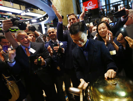 Alibaba Group Holding Ltd founder Jack Ma (C) rings a ceremonial bell to start trading during his company's initial public offering (IPO) under the ticker "BABA" at the New York Stock Exchange in New York September 19, 2014. REUTERS/Brendan McDermid