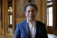 Venezuelan conductor Gustavo Dudamel poses after a press conference at the Palais Garnier opera house, in Paris Friday, April 16, 2021. The Paris Opera announced the arrival of Gustavo Dudamel as music director for six seasons. (AP Photo/Christophe Ena)