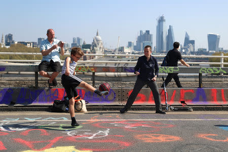 Climate change activists play football on Waterloo Bridge during the Extinction Rebellion protest in London, Britain April 20, 2019. REUTERS/Simon Dawson