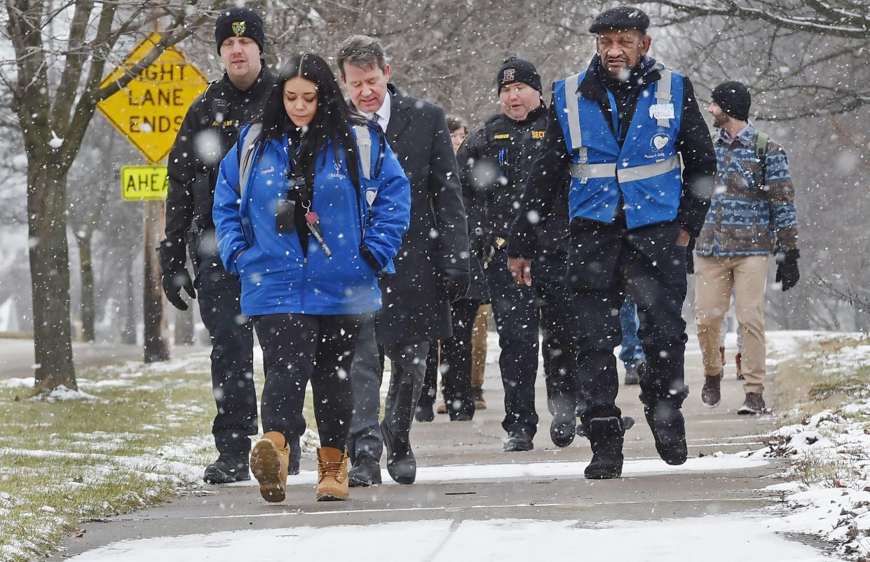 Walking from United Way offices at the former Wayne Middle School to Edison Elementary, Erie School District Superintendent Brian Polito, third from left, joins Blue Coats members Taylor Yahner, second from left, and Daryl Craig, right, to point out challenges students face in walking to school in winter, such as unshoveled sidewalks, poorly marked intersections and inattentive drivers.