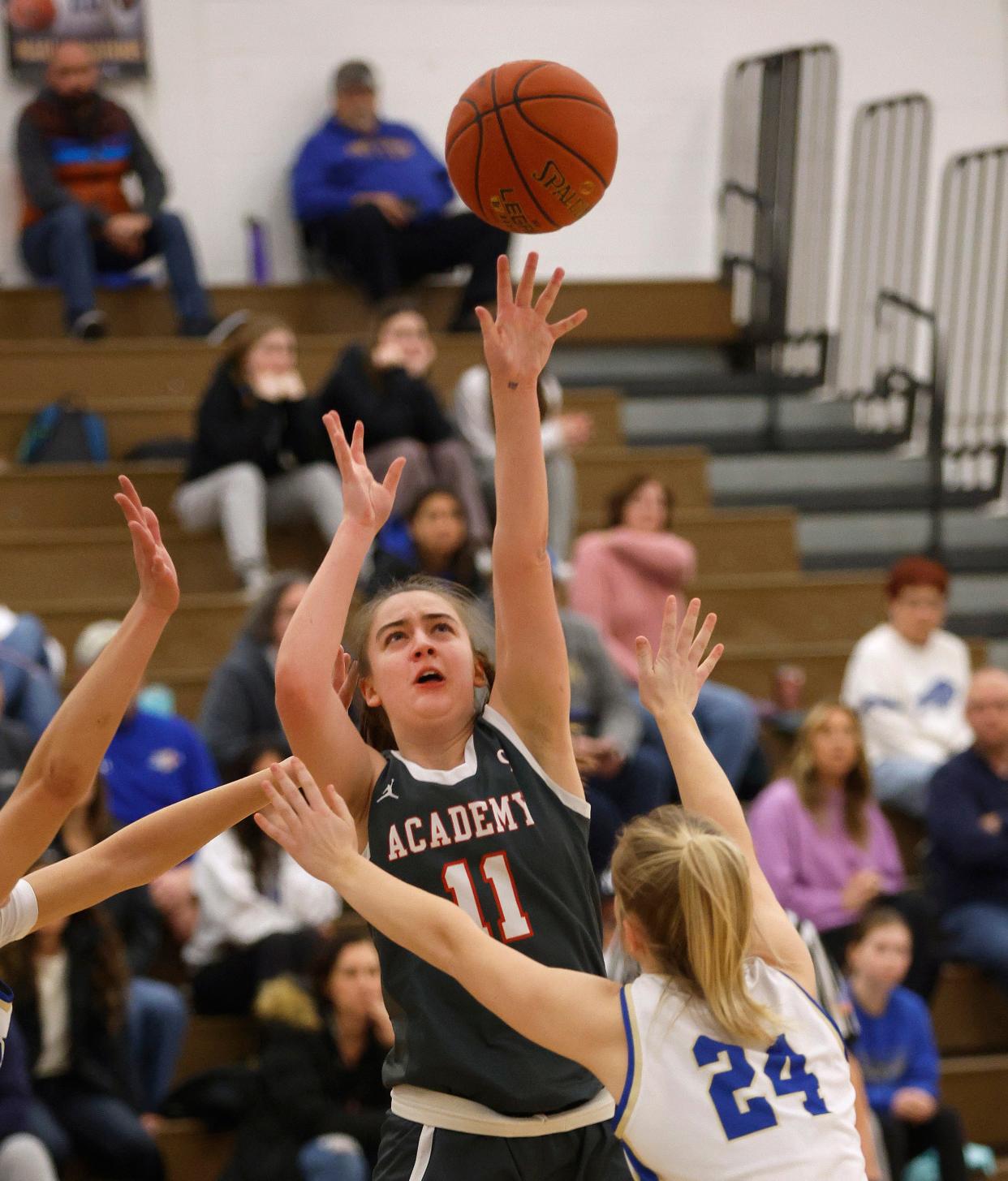 Canandaigua’s Kyleigh Chapman turns and shoots over Schroeder’s Rachel DeMocker as the shot clock ends down.