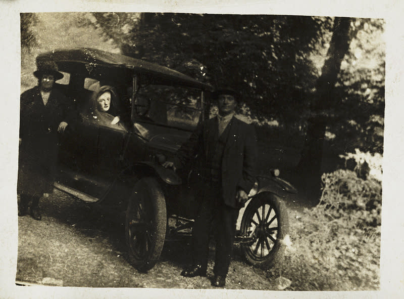 Two of William Hope's friends lean on their motor car while a "spirit"—the couple's deceased son—is revealed at the wheel. (William Hope, c. 1920, National Media Museum Collection)