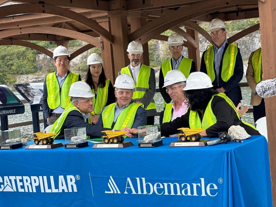 Albemarle Corp. won a $90 million Defense Department grant to help support reopening a lithium min in Kings Mountain. Seen here, Albemarle and Caterpillar Inc. officials in September at the lithium mine as they celebrate a deal to collaborate on sustainable mining technologies.