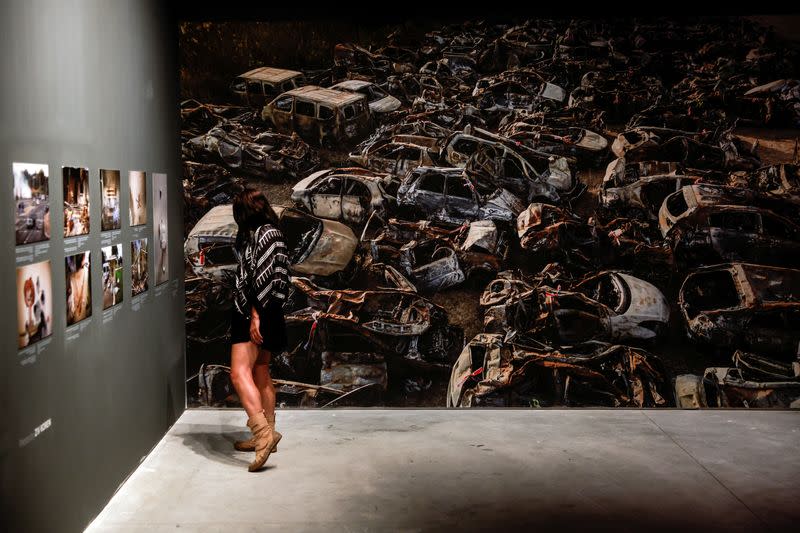 A woman views a picture at the "From Darkness to Light" interactive exhibition about the deadly October 7 attack Palestinian Islamist group Hamas from Gaza, in Jerusalem