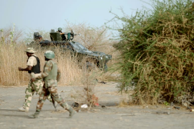 Nigerian soldiers patrol in the north of Borno state close to former Boko Haram camp on June 5, 2013 near Maiduguri