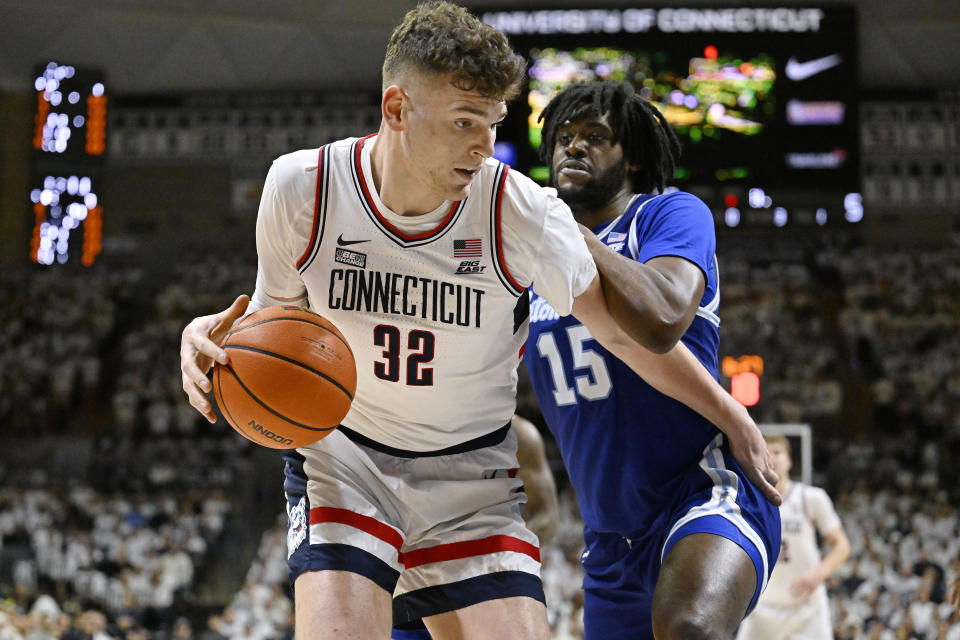 UConn center Donovan Clingan (32) is guarded by Seton Hall center Jaden Bediako (15) in the first half of an NCAA college basketball game, Sunday, March 3, 2024, in Storrs, Conn. (AP Photo/Jessica Hill)