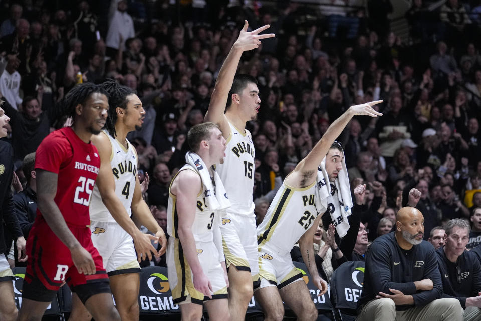 The Purdue bench celebrates, including center Zach Edey (15), guard Ethan Morton (25) guard Braden Smith (3) during the second half of an NCAA college basketball game against Rutgers in West Lafayette, Ind., Thursday, Feb. 22, 2024. (AP Photo/Michael Conroy)