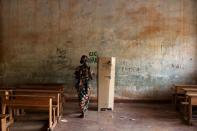 A woman walks to a polling booth during the second round of presidential and legislative elections in the mostly Muslim PK5 neighbourhood of Bangui, Central African Republic, February 14, 2016. REUTERS/Siegfried Modola