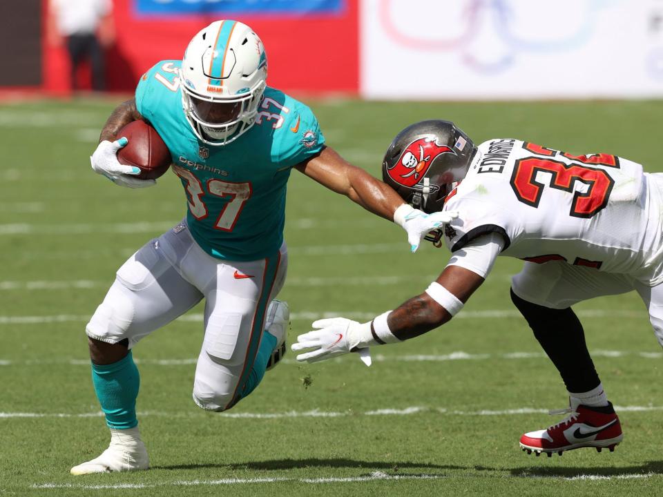 Myles Gaskin breaks free from a Tampa Bay Buccaneers defender.