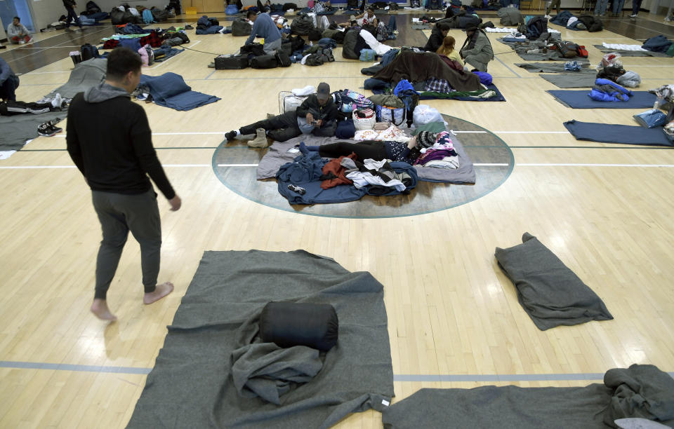 FILE - Migrants rest at a makeshift shelter in Denver, Jan. 6, 2023. Five mayors from around the U.S. want a meeting with President Joe Biden to ask for help controlling the continued arrival of large groups of migrants to their cities. The mayors of Denver, Chicago, Houston, New York and Los Angeles say in a letter to Biden that there has been little to no coordination, support or resources and that is leading to a crisis. (AP Photo/Thomas Peipert)