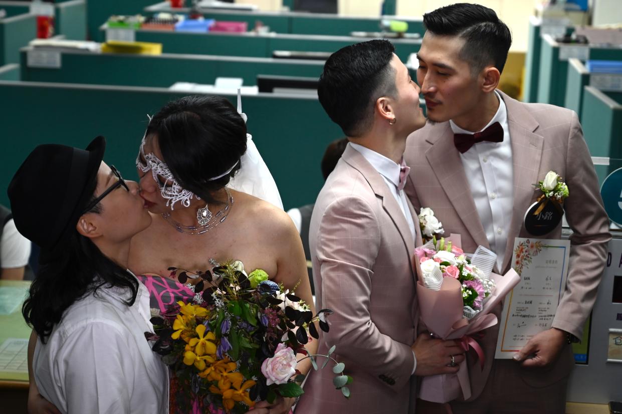 Two gay couples in Taiwan registered their marriages in Taipei on 24 May 2019, a week after lawmakers in the island approved a bill legalising gay marriages. AFP via Getty Images file photo.  