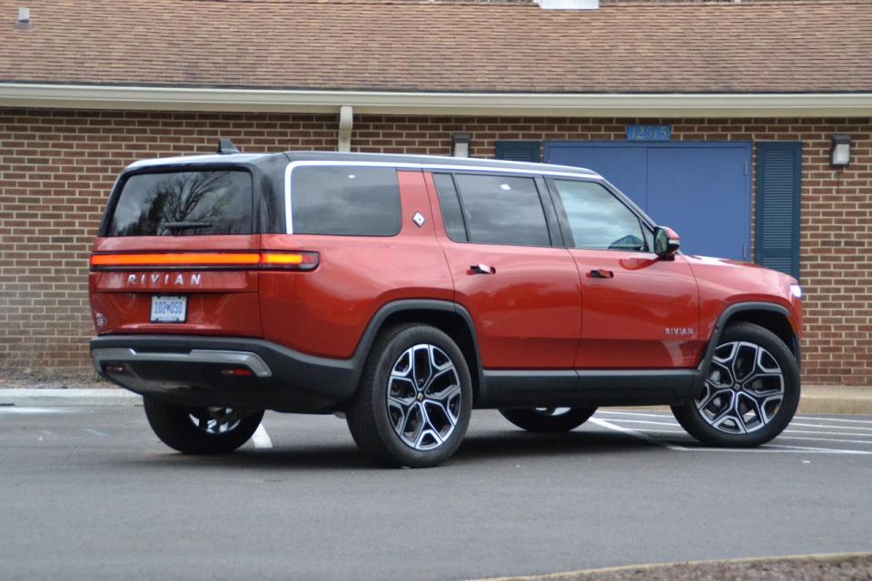 The Rivian SUV’s cargo area is spacious and opens with a Range Rover-like split door, with an upper hatch covering most of the opening and a small lower tailgate providing convenient seating when open.