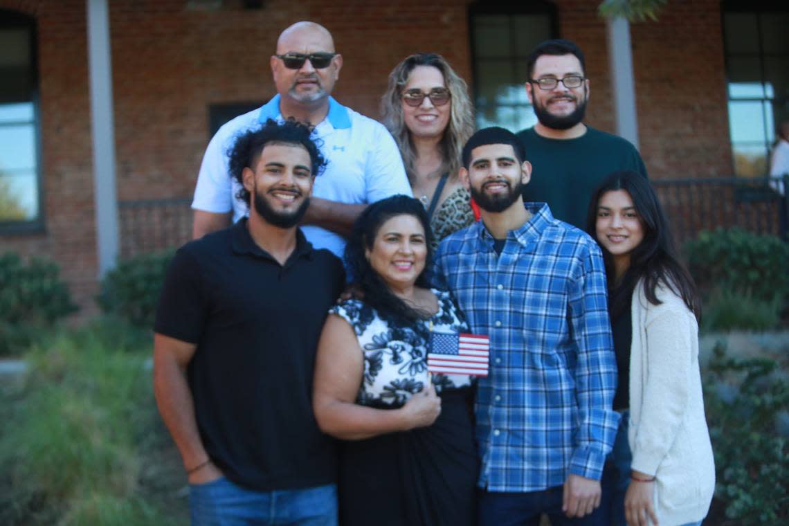 Sandra Chávez de Torres with her three adult children, her nephew, her brother, and sister-in-law who eagerly waited for her to emerge from the immigration office in downtown Fresno with her naturalization certificate and American flag in hand after taking the oath of allegiance to the United States flag Thursday (Sept. 22) at the offices of the United States Citizenship and Immigration Services in Fresno.