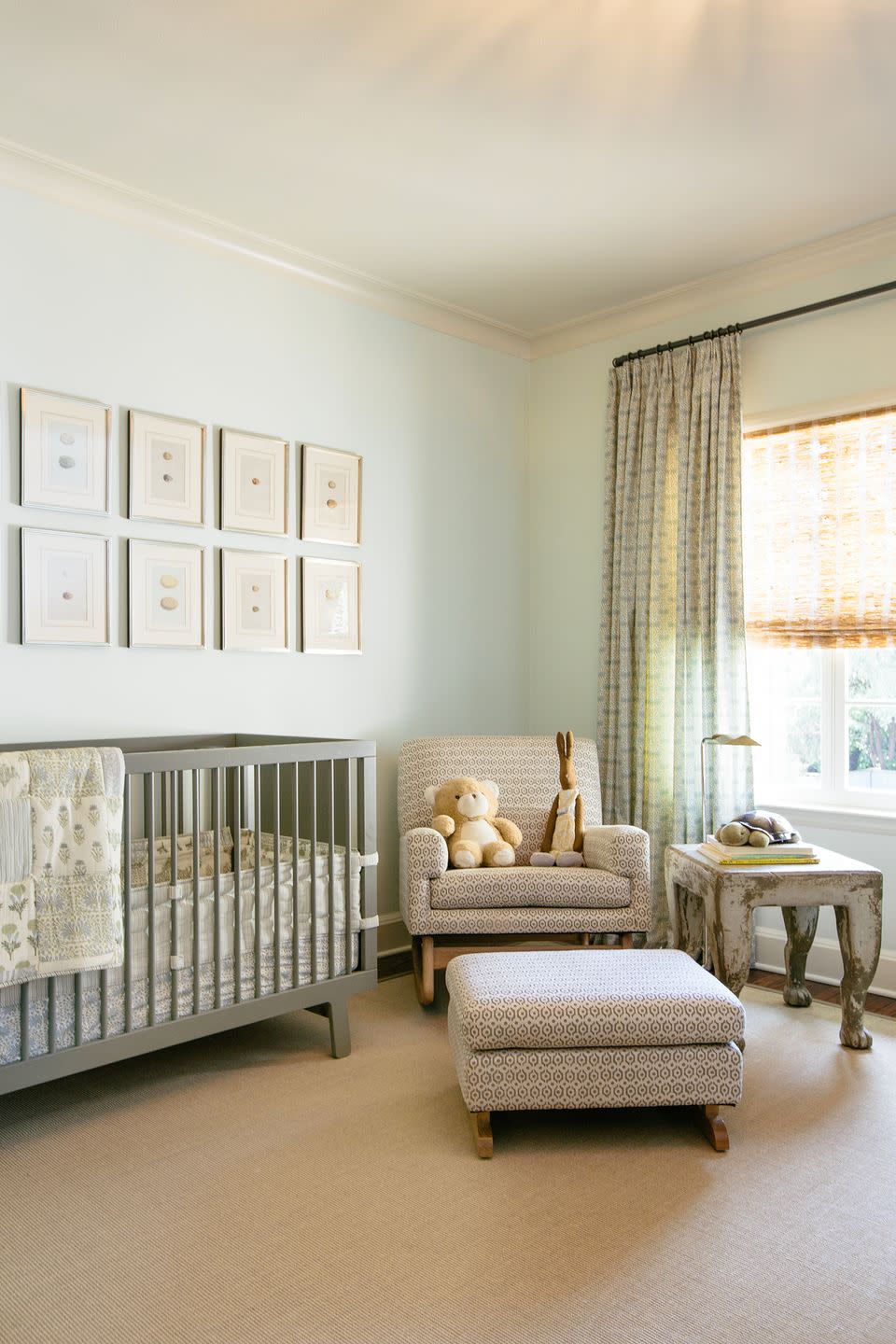 <p>This nursery designed by <a href="https://www.jeanliudesign.com/" rel="nofollow noopener" target="_blank" data-ylk="slk:Jean Liu;elm:context_link;itc:0;sec:content-canvas" class="link ">Jean Liu</a> is a masterclass in unique and unexpected (yet still neutral) color schemes. Pastel mint green walls, curtains, and bedding keep things crisp and fresh and match nicely with the gray accents, while the pale olive green crib speaks to the warmer camel and creams tones throughout. </p>