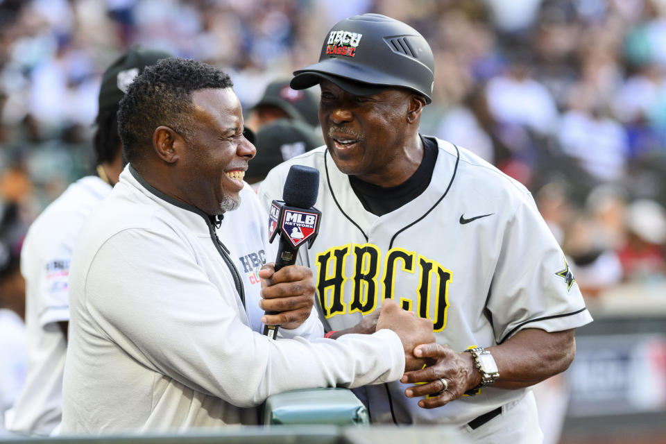 Major League Baseball Hall of Fame player Ken Griffey Jr., left, laughs with National League coach Vince Coleman, right, during the second inning of the HBCU Swingman Classic baseball game during All-Star Week, Friday, July 7, 2023, in Seattle. (AP Photo/Caean Couto)