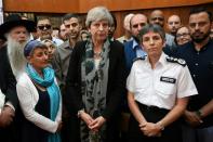 Britain's Prime Minister Theresa May (C) and Metropolitan Police Commissioner, Cressida Dick (C-R) talk to faith leaders at Finsbury Park Mosque in north London on June 19, 2017