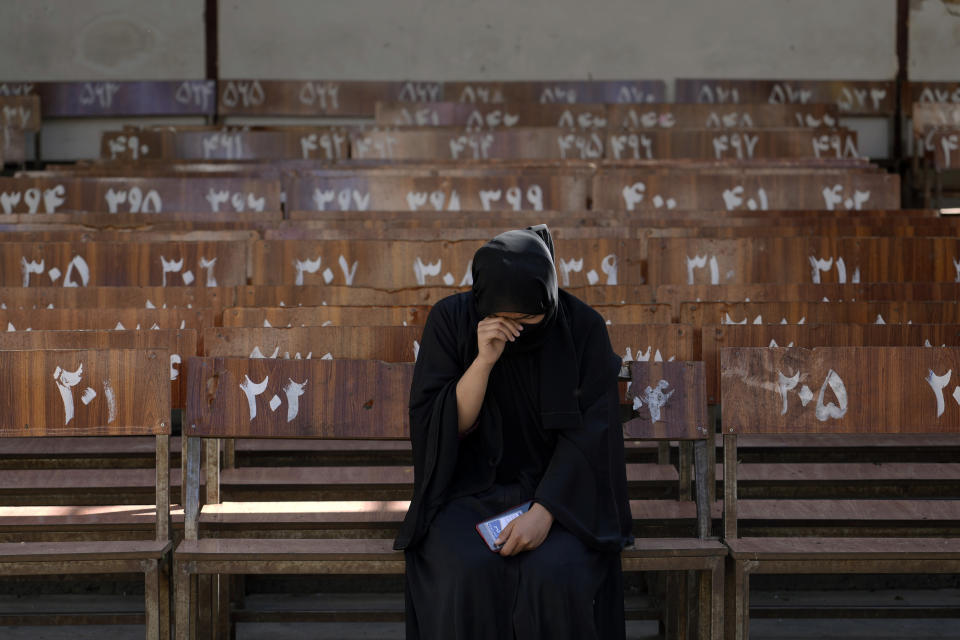 A 19-year old Hazara Afghan girl sits and cries on the bench she was sitting on, during Friday's suicide bomber attack on a Hazara education center, in Kabul, Afghanistan, Saturday, Oct. 1, 2022. Afghanistan's Hazaras, who are mostly Shiite Muslims, have been the target of a brutal campaign of violence for the past several years. (AP Photo/Ebrahim Noroozi)