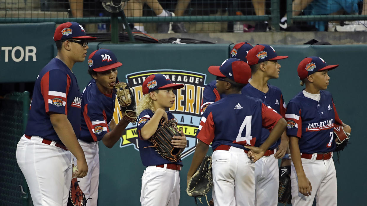 The Elizabeth, New Jersey Little League team waits to take the field against Barrington, Rhode Island during the second inning of a baseball game at the Little League World Series tournament in South Williamsport, Pa., Tuesday, Aug. 20, 2019. Elizabeth, New Jersey won the game 2-0. (AP Photo/Tom E. Puskar)