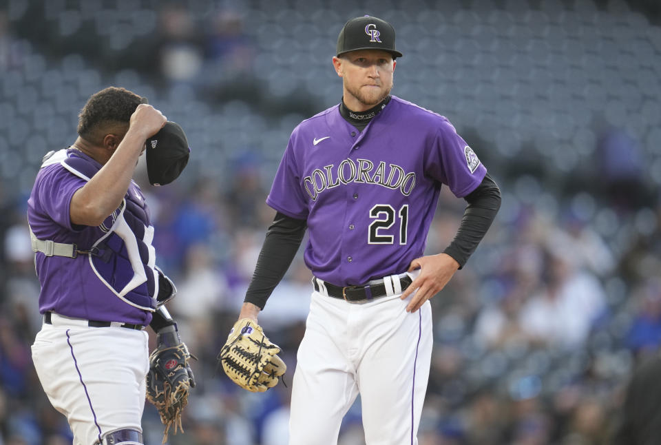 Colorado Rockies starting pitcher Kyle Freeland (21) reacts after giving up an RBI-double to Chicago Cubs' Seiya Suzuki in the first inning of a baseball game Thursday, April 14, 2022, in Denver. (AP Photo/David Zalubowski)