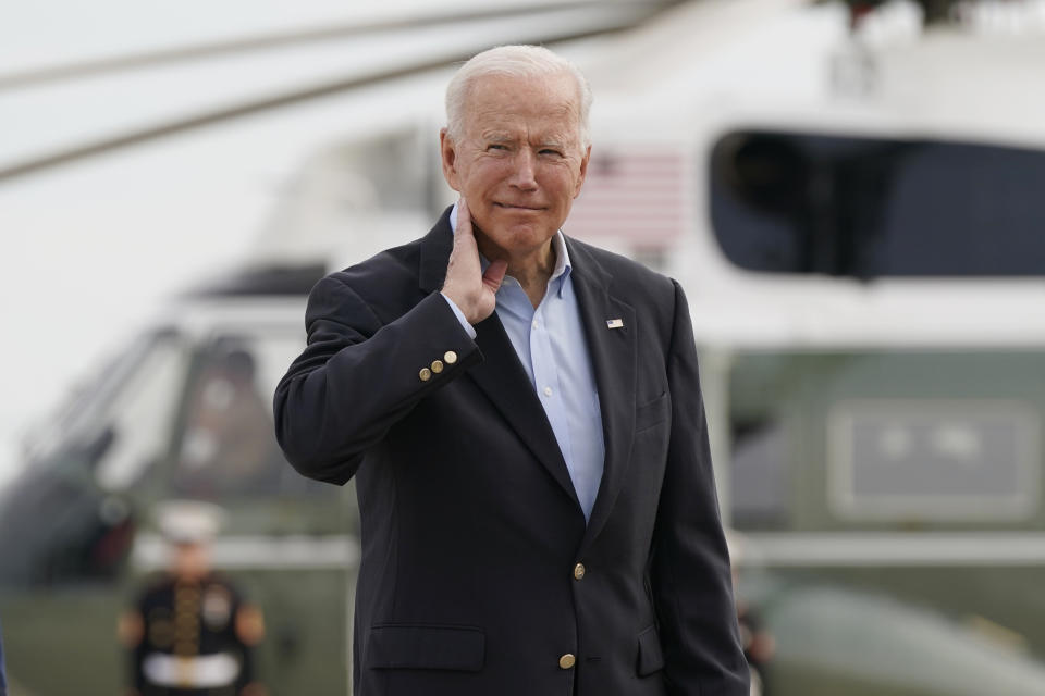 President Joe Biden pantomimes how he earlier had to brush a cicada off his neck as he and first lady Jill Biden prepare to board Air Force One, Wednesday, June 9, 2021, at Andrews Air Force Base, Md. Biden is embarking on the first overseas trip of his term, and is eager to reassert the United States on the world stage, steadying European allies deeply shaken by his predecessor and pushing democracy as the only bulwark to the rising forces of authoritarianism. (AP Photo/Patrick Semansky)