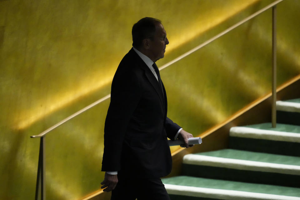 Russian Foreign Minister Sergey Lavrov, center, is escorted to the podium by protocol to address the 78th session of the United Nations General Assembly, Saturday, Sept. 23, 2023 at United Nations headquarters. (AP Photo/Mary Altaffer)