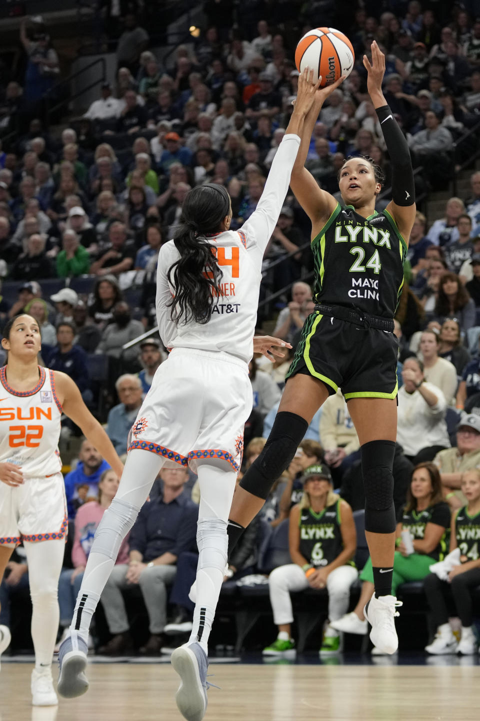 Minnesota Lynx forward Napheesa Collier, right, shoots over Connecticut Sun forward DeWanna Bonner during the second half of Game 5 of a WNBA basketball semifinals, Tuesday, Oct. 8, 2024, in Minneapolis. (AP Photo/Abbie Parr)