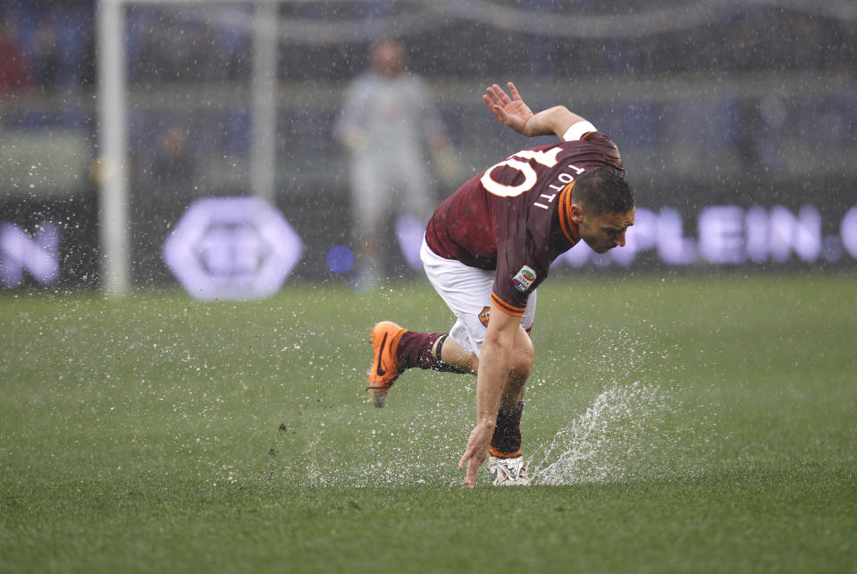 AS Roma forward Francesco Totti falls on the slippery field during Italian Serie A soccer match between AS Roma and Parma at Rome's Olympic stadium, Sunday, Feb.2, 2014. The match was suspended a few minutes later due to bad weather conditions. (AP Photo/Alessandra Tarantino)