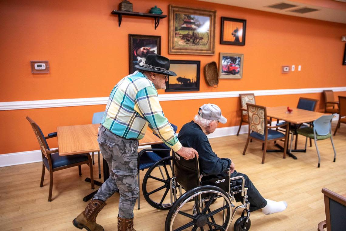 Bill Thomas, age 75, pushes Charles Andrews, age 84, in a wheelchair to an afternoon snack break at The Oaks of Loris. The assisted living facility is under new management and part of the property is undergoing mold remediation after being cited by the Department of Health and Environmental Control last year. Thirty-nine senior citizens currently live in the facility. March 2, 2023.